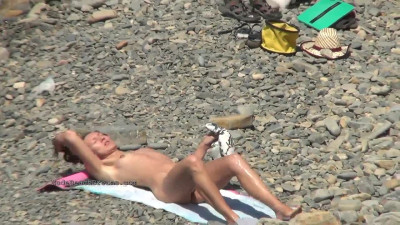 Hidden camera record few nudist on nude beach