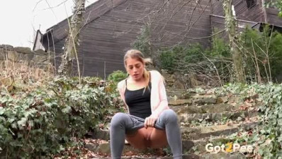 Sporty hot blonde girl pulls down her grey yoga pants and pees outside