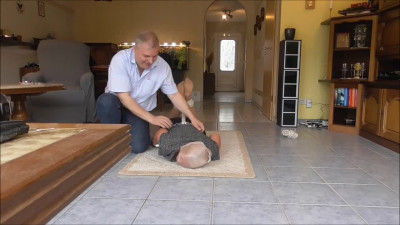 German girl wearing a nylon stocking on her head is tickled on the floor