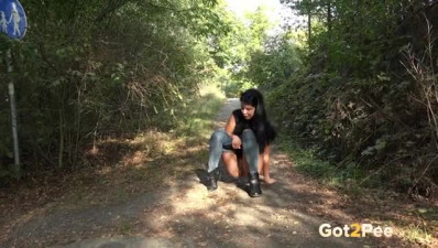 Dark haired babe caught peeing in a country lane