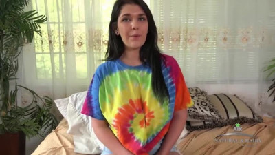 April Dawn removes her tie dye shirt and masturbates